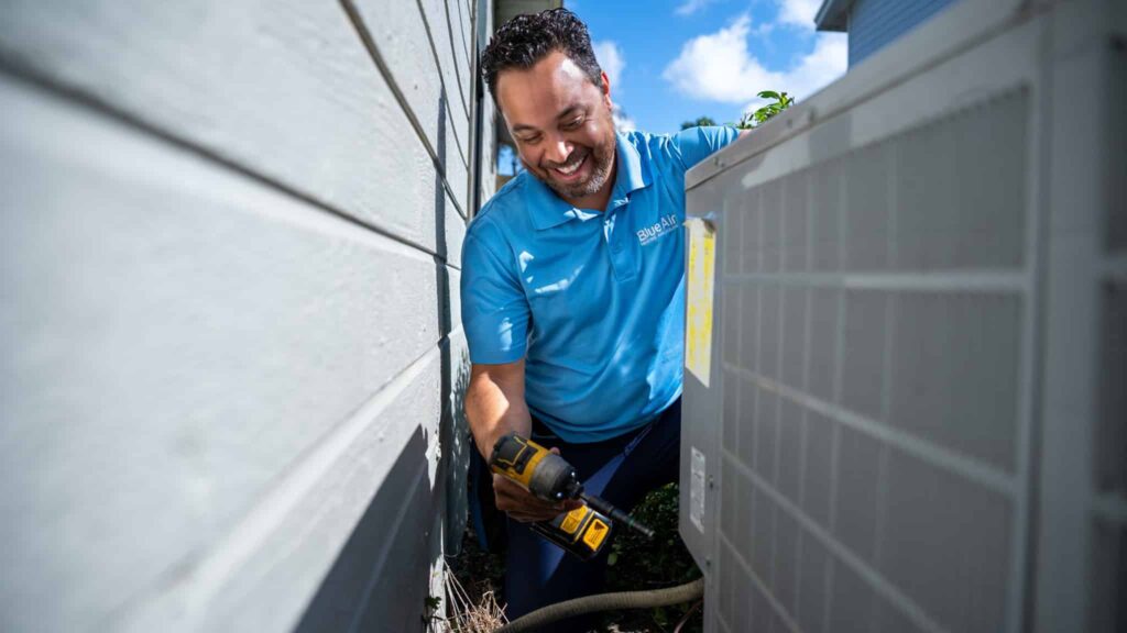 Blue Air technician working on an outdoor AC unit